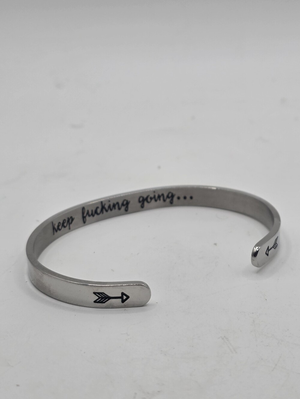 Silver Tone Metal Cuff Bracelet Engraved "Keep F'ing Going" Arrow